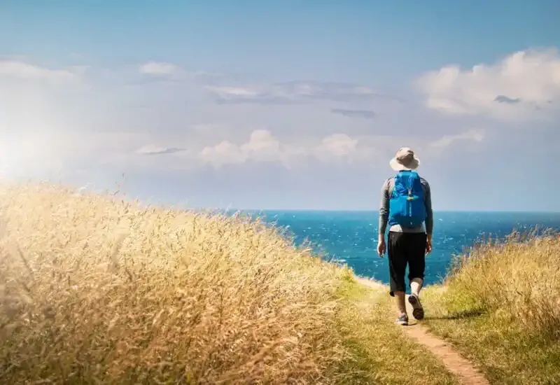 A person walking towards the horizon